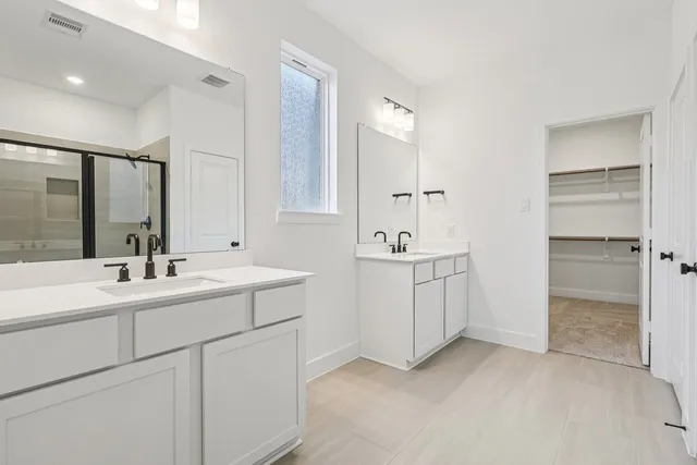 a bathroom with a sink double vanity and a mirror