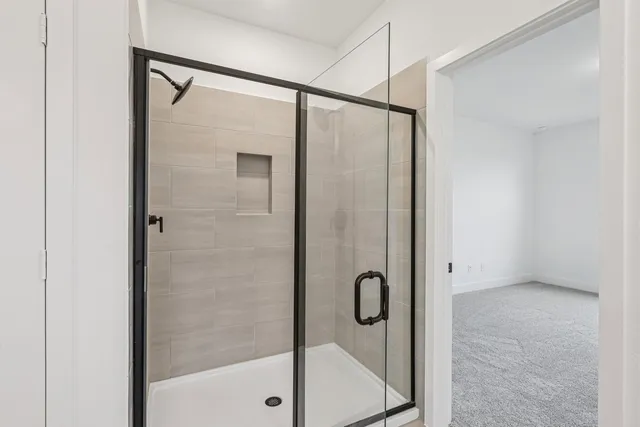 a bathroom with a glass shower door