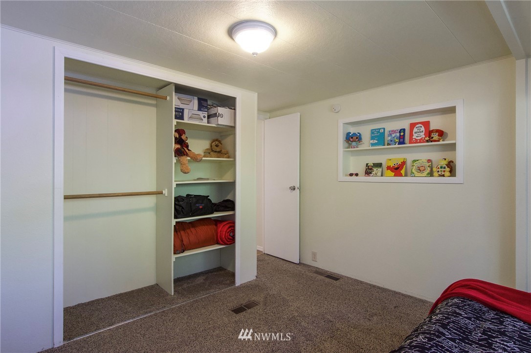 222 Webb Road Sequim, WA 98382 - Photo 22 of 40 a bedroom with a bed and a window