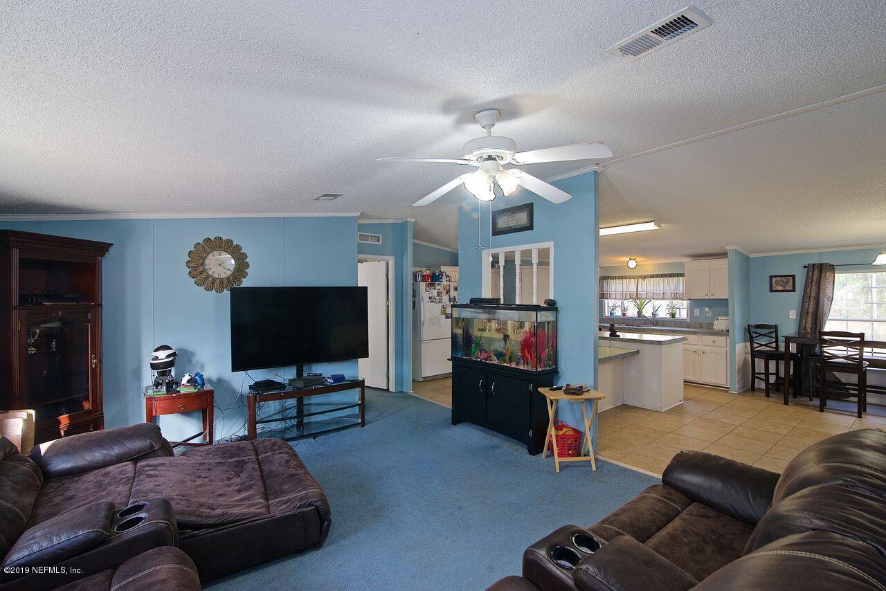 45214 Arline Road Callahan, FL 32011 - Photo 6 of 18 a living room with furniture and a flat screen tv