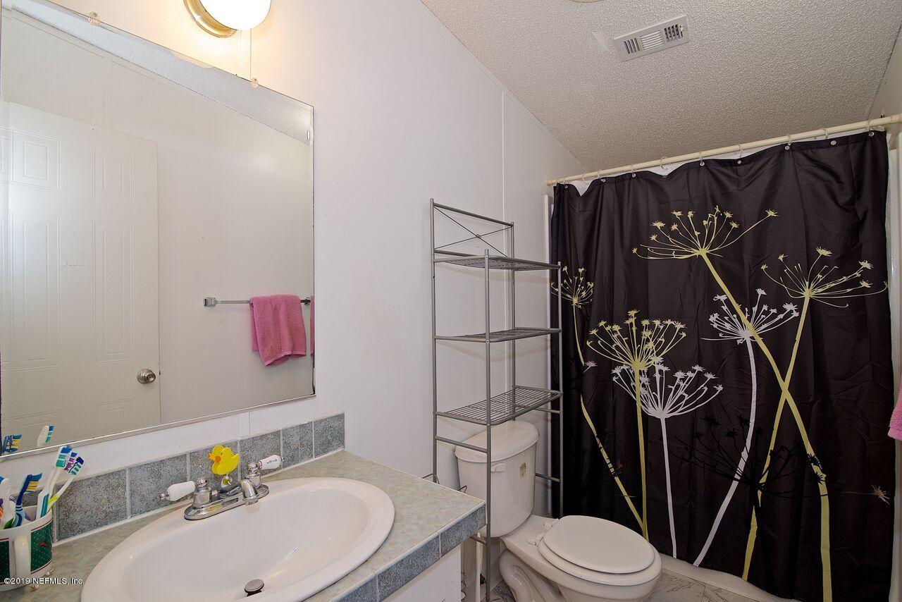 45214 Arline Road Callahan, FL 32011 - Photo 10 of 18 a bathroom with a sink toilet and shower