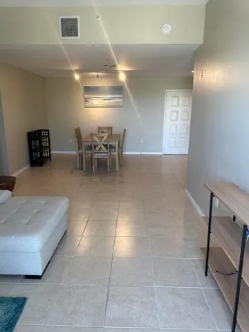 a living room with furniture and white doors