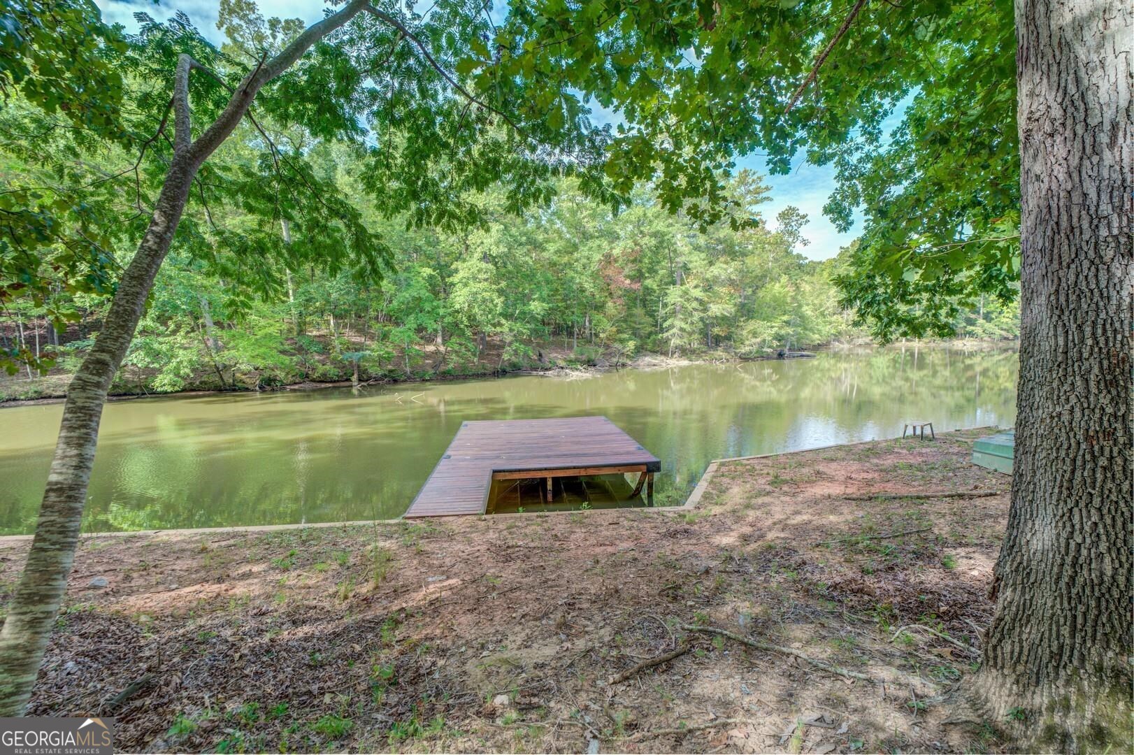 0 Summit View Road Jackson, GA 30233 - Photo 12 of 23 a view of a lake with a yard and large trees