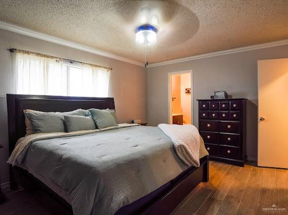 3200 Hummingbird Avenue McAllen, TX 78504 - Photo 16 of 31 a bedroom with a bed and a chandelier