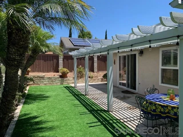 2710 Glasgow Drive Carlsbad, CA 92010 - Photo 6 of 10 a view of a patio with table and chairs potted plants and palm tree