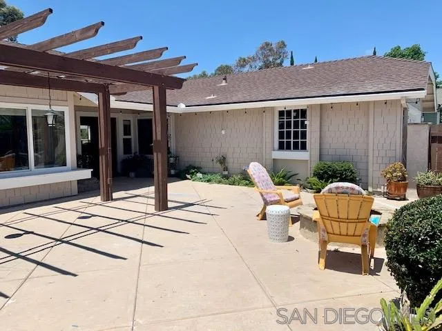 2710 Glasgow Drive Carlsbad, CA 92010 - Photo 9 of 10 a view of a patio with table and chairs potted plants and floor to ceiling window