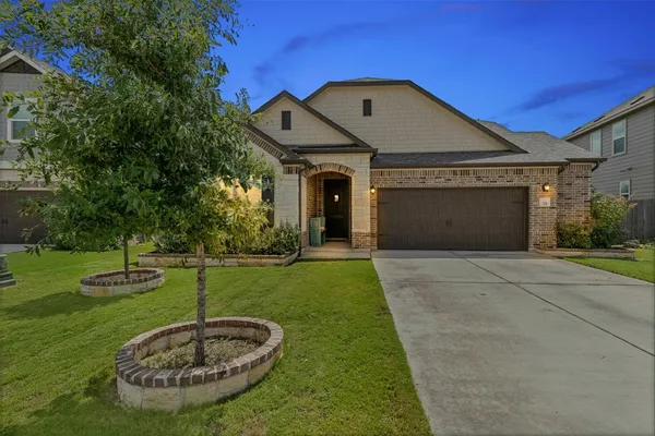 a front view of a house with a yard