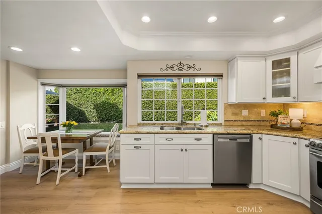 a kitchen with a window and chairs
