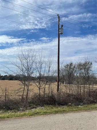 a street sign on a sidewalk next to a road