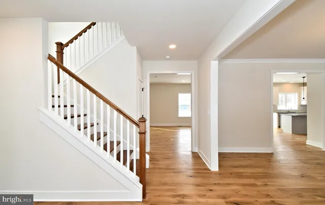 a view of entryway and hall with wooden floor