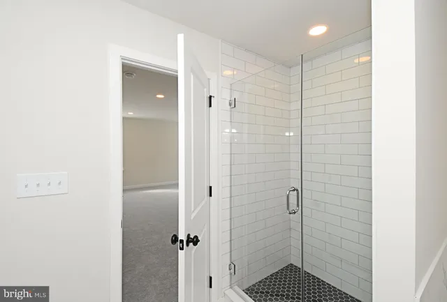 a spacious bathroom with a shower sink and mirror