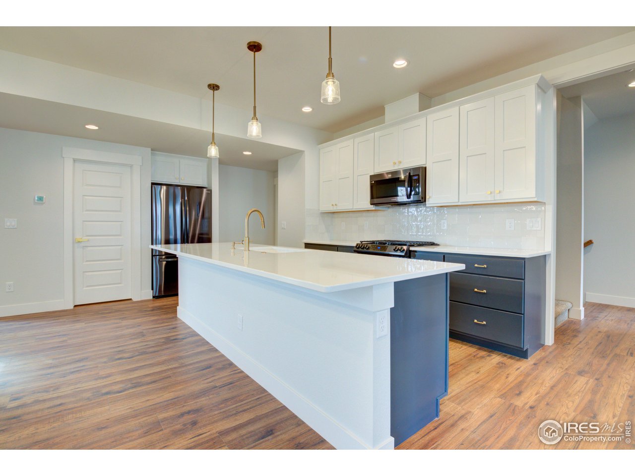 5701 2nd Road Greeley, CO 80634 - Photo 8 of 26 The island is ready for hectic mornings with a breakfast bar