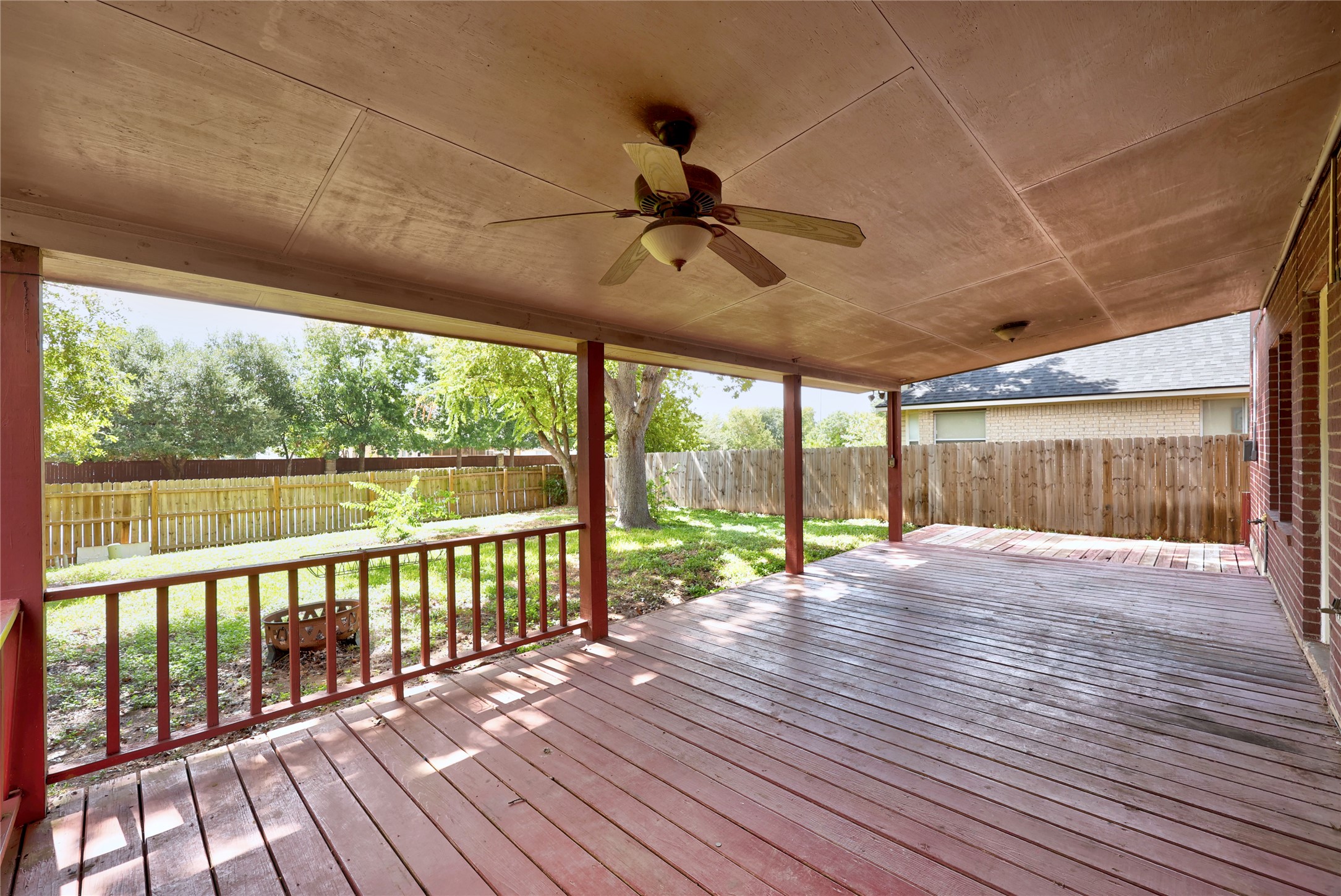 13217 Rochester Lane Austin, TX 78753 - Photo 29 of 30 An expansive wooden deck overlooks the grassy backyard and surrounding wood fencing.