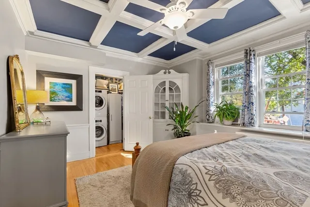 a spacious bedroom with a large bed and a large window