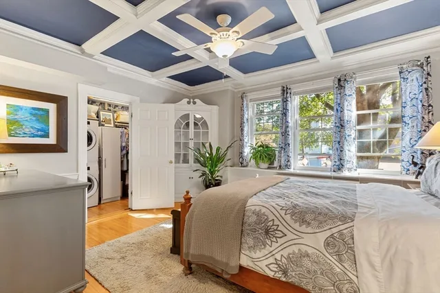 a spacious bedroom with a large bed and a chandelier