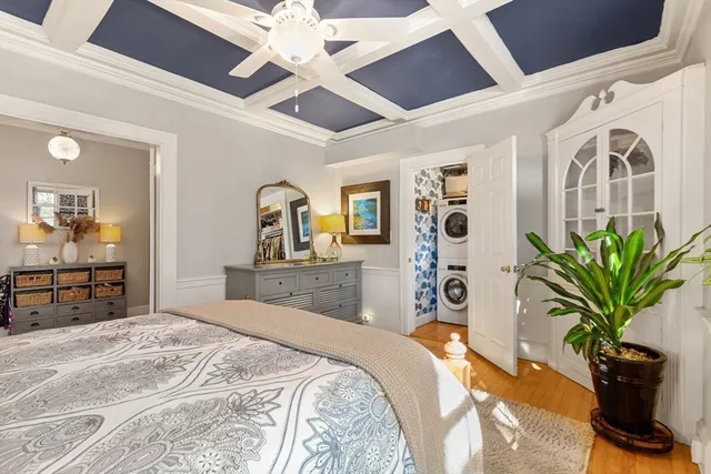 a bedroom with a large bed and a chandelier