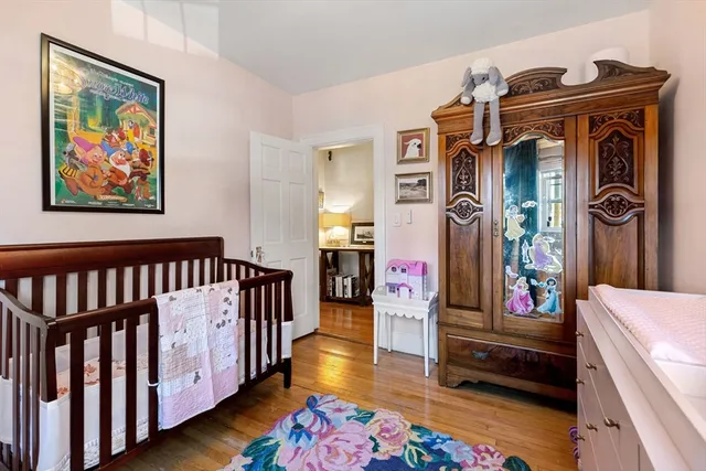 a bedroom with furniture and wooden floor