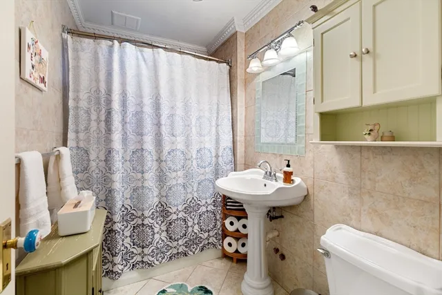 a bathroom with a sink toilet and a mirror