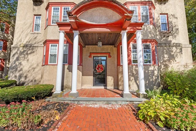 a view of a pool with a bench and trees in the background