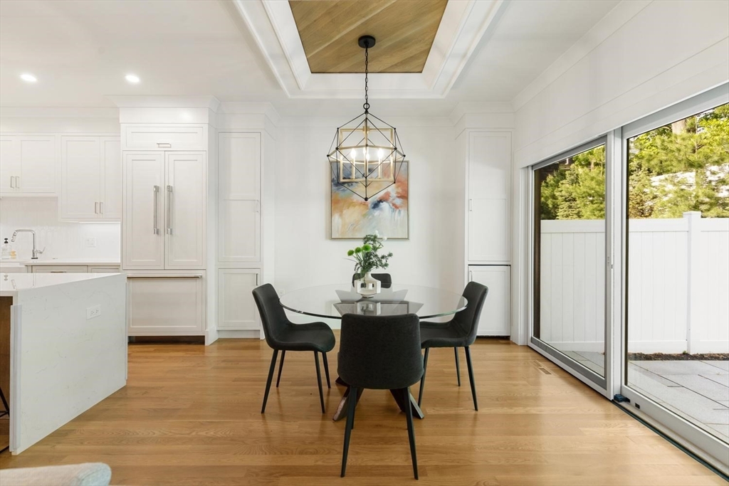 1124 Chestnut Street Newton, MA 02464 - Photo 7 of 41 a dining room with furniture a chandelier and wooden floor