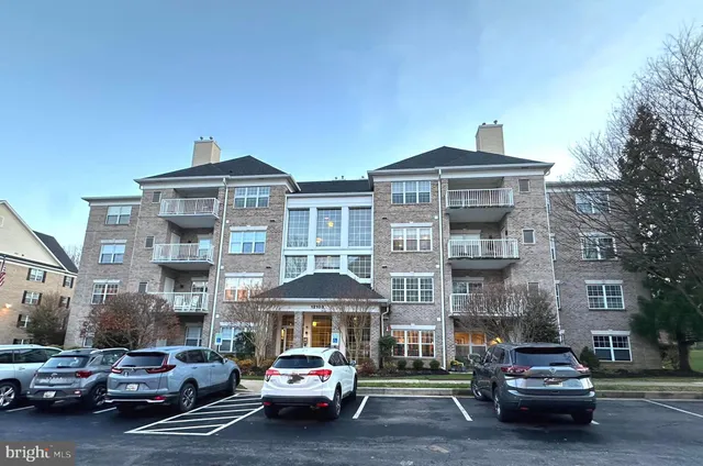 a car parked in front of a brick house