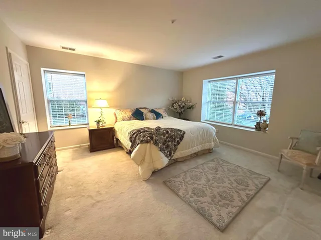 a bedroom with a large bed and a couch