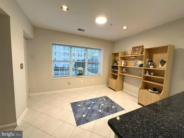 a kitchen with stainless steel appliances kitchen island granite countertop a refrigerator and stove