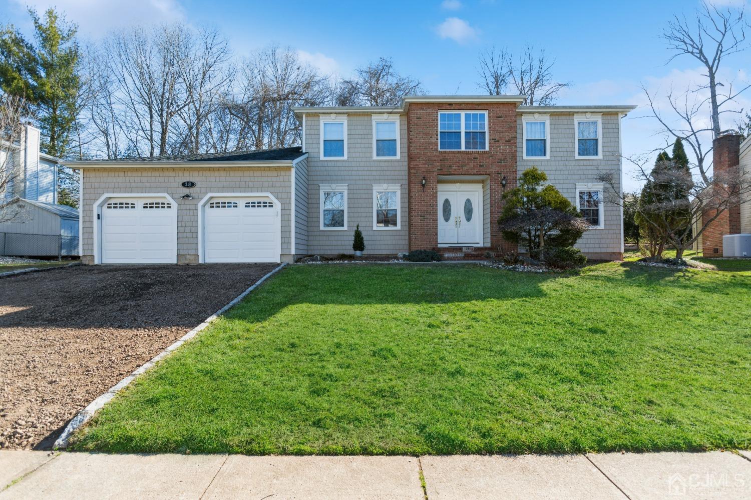 18 Churchill Road Edison, NJ 08820 - Photo 1 of 35 a front view of a house with a garden and yard