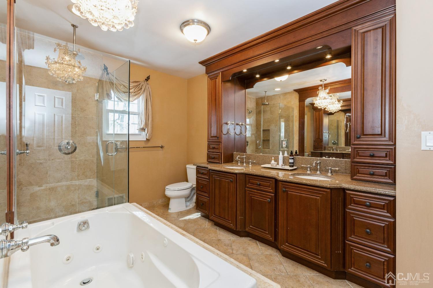 18 Churchill Road Edison, NJ 08820 - Photo 19 of 35 a bathroom with a bathtub shower sink mirror and toilet