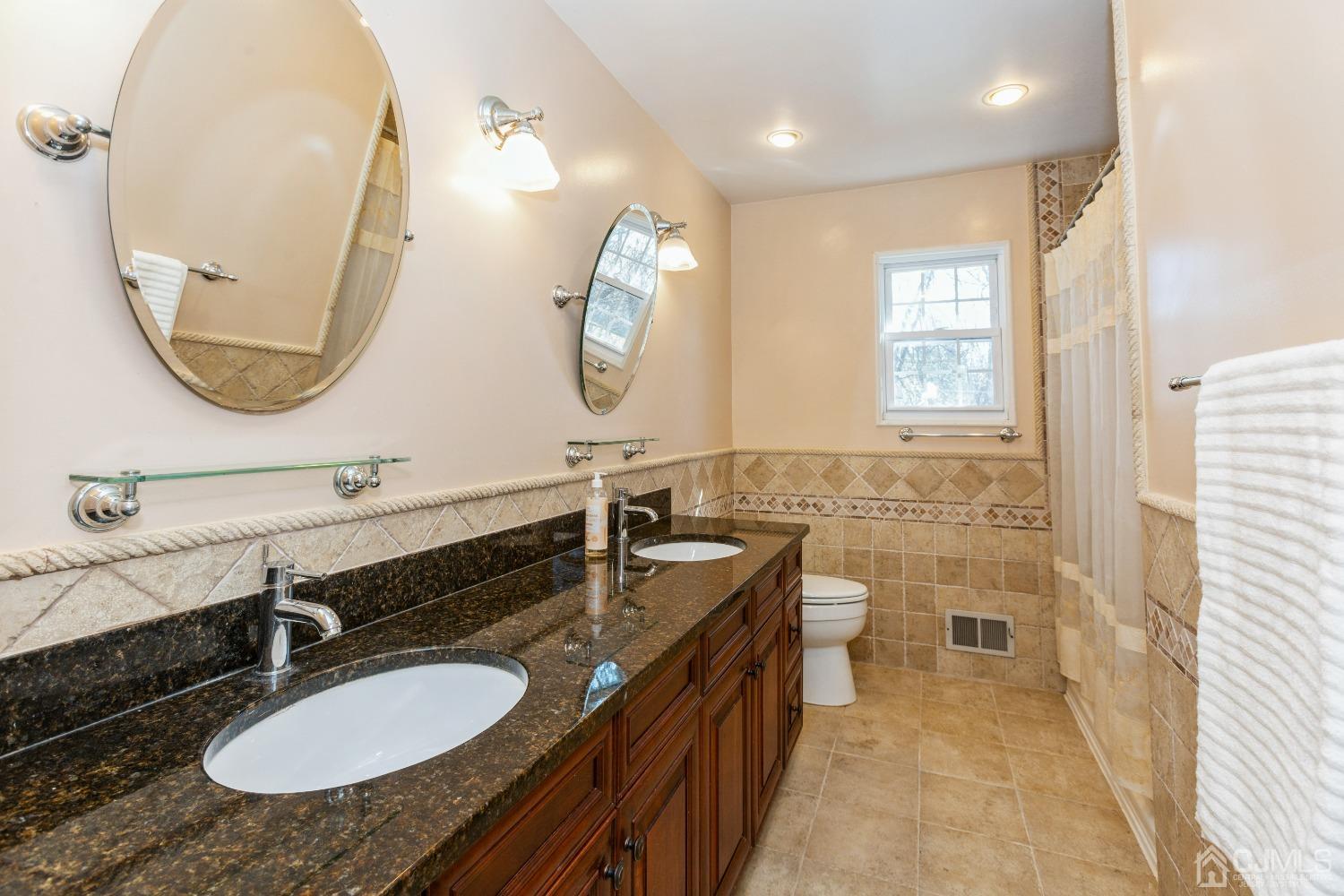18 Churchill Road Edison, NJ 08820 - Photo 20 of 35 a bathroom with a sink double vanity granite and a mirror