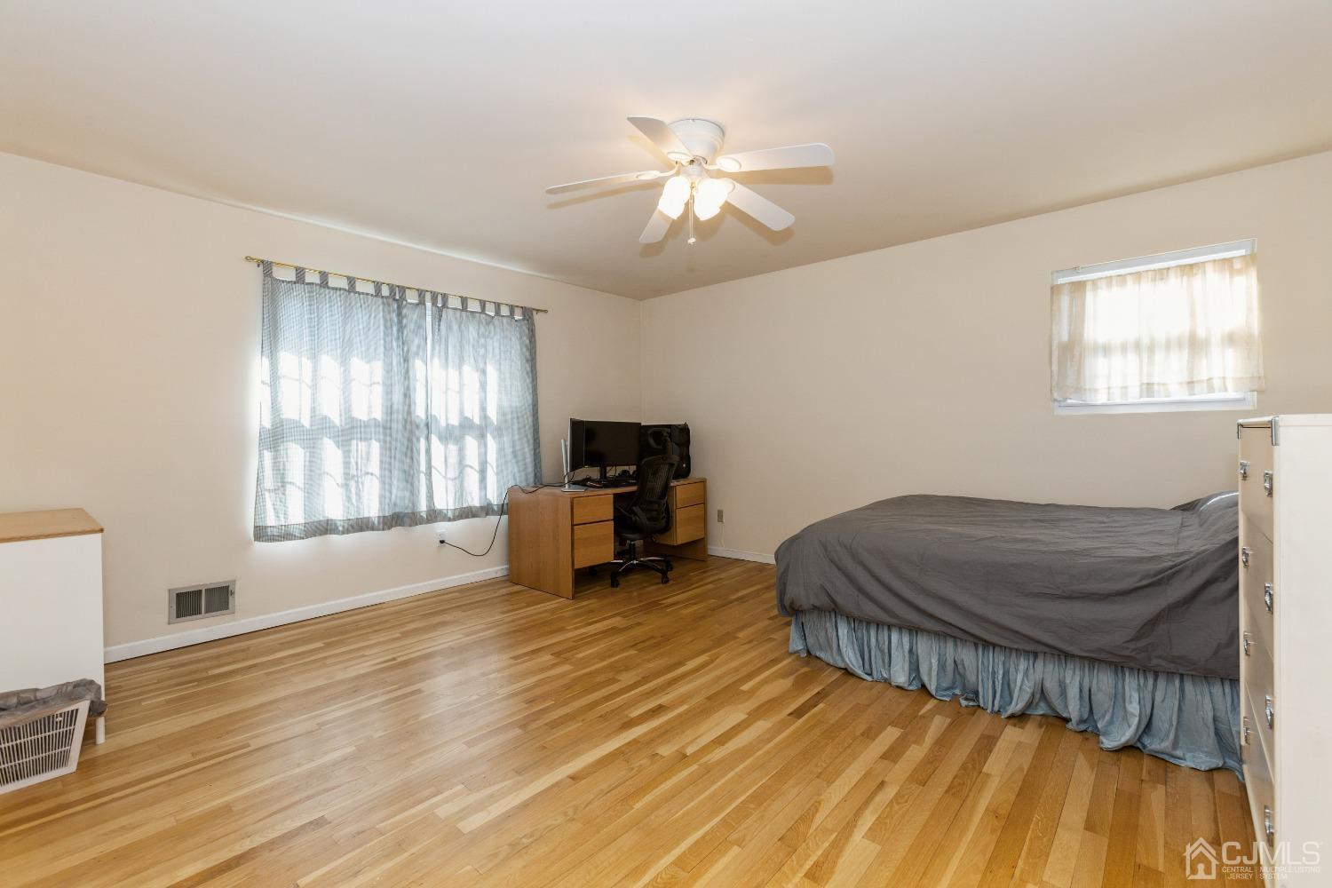 18 Churchill Road Edison, NJ 08820 - Photo 23 of 35 a spacious bedroom with a bed and a chandelier