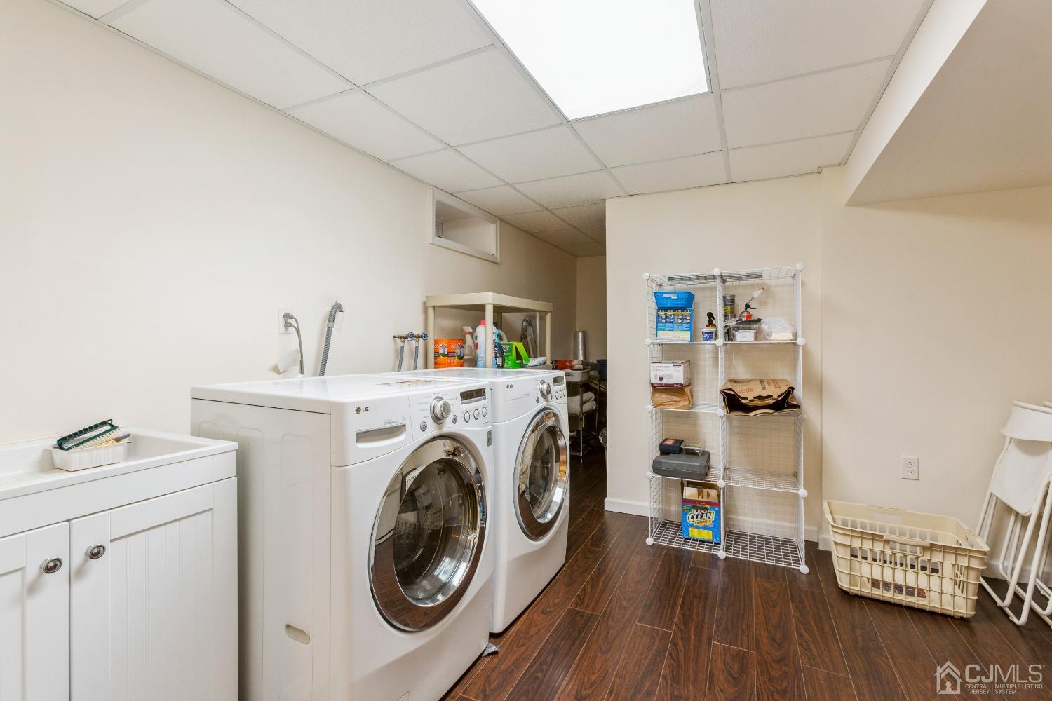 18 Churchill Road Edison, NJ 08820 - Photo 24 of 35 a utility room with dryer washer and a view of living room