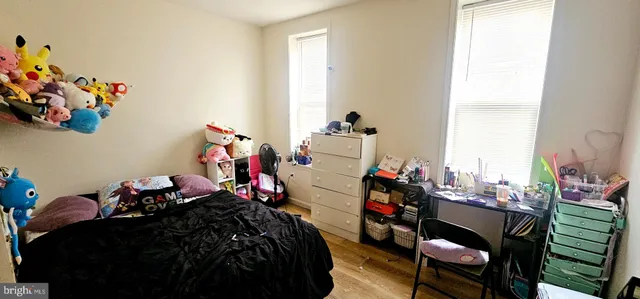 a bed room with a bed mirror and a window