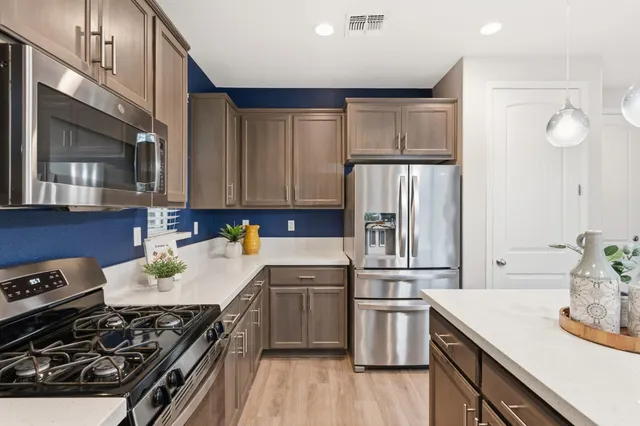 a kitchen with a stove a sink and a refrigerator