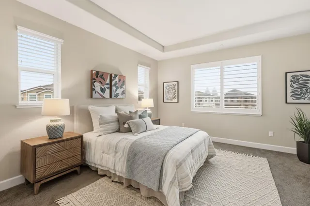 a bedroom with a bed and paintings on the wall
