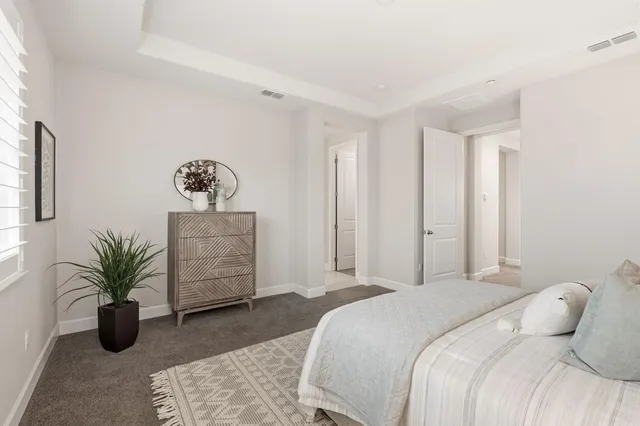 a spacious bathroom with a double vanity sink toilet mirror and bathtub