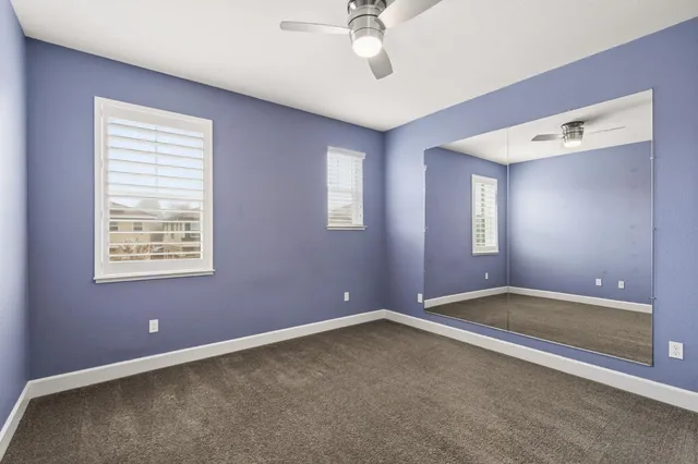 a bathroom with a sink a toilet a mirror and shower