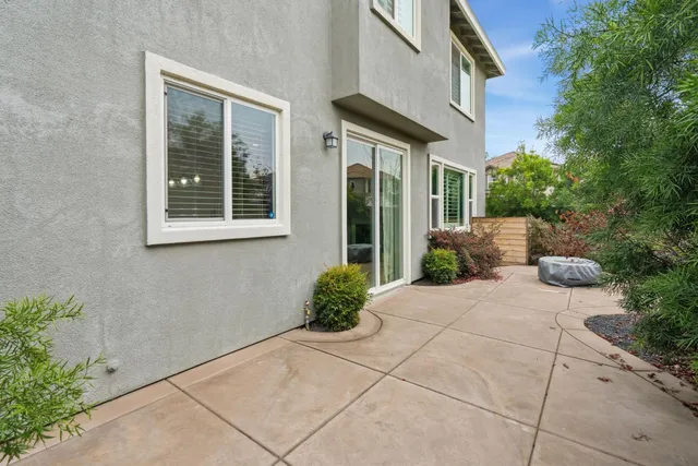 a view of a house with a small yard and flower plants