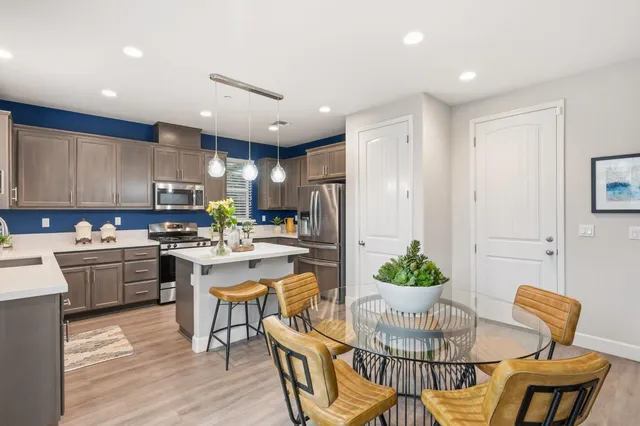 a kitchen with a table and chairs