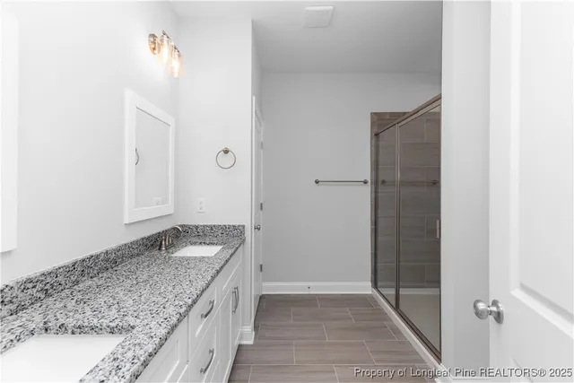 a bathroom with a glass shower door