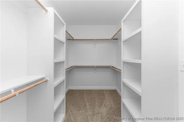 a view of a hallway with wooden shelves
