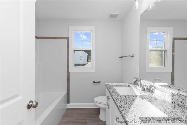 a view of a bathroom from the hallway