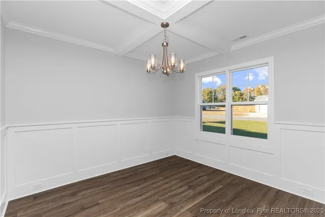 a view of an empty room with a fireplace and a window