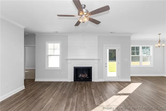 a view of kitchen with cabinets a fireplace and wooden floor