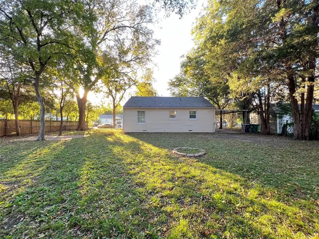 a view of a house with a yard and tree
