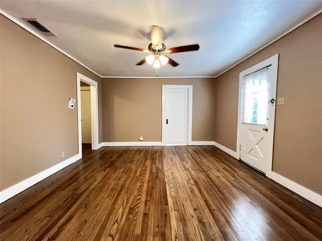 wooden floor in an empty room with a window