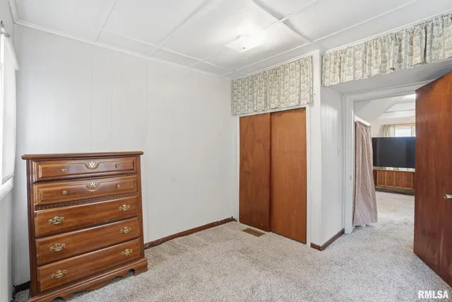 a view of walk in closet with clothes