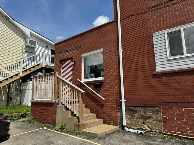 a view of front door of house with stairs