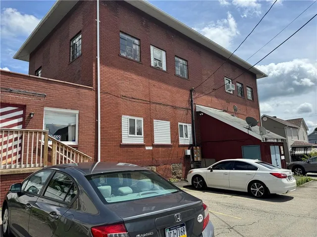 a front view of a house with parking space