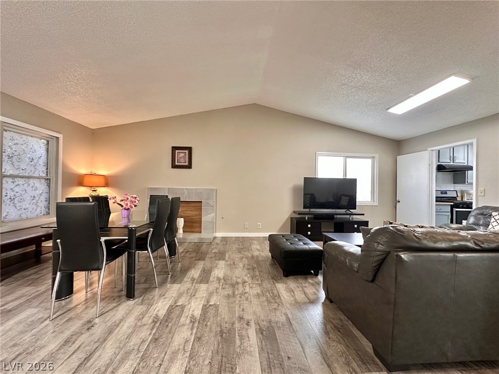 2340 Viewcrest Road Henderson, NV 89014 - Photo 6 of 36 This versatile living space features vaulted ceilings, inviting both relaxation and intimate dining experiences.